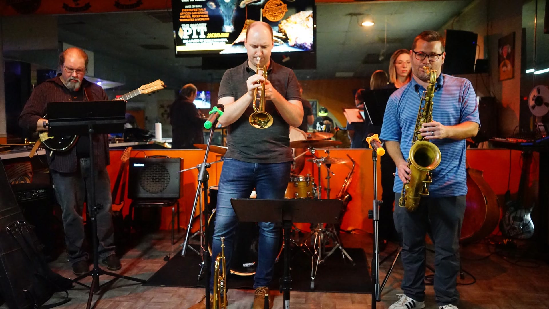 Musicians performing live in a vibrant venue.